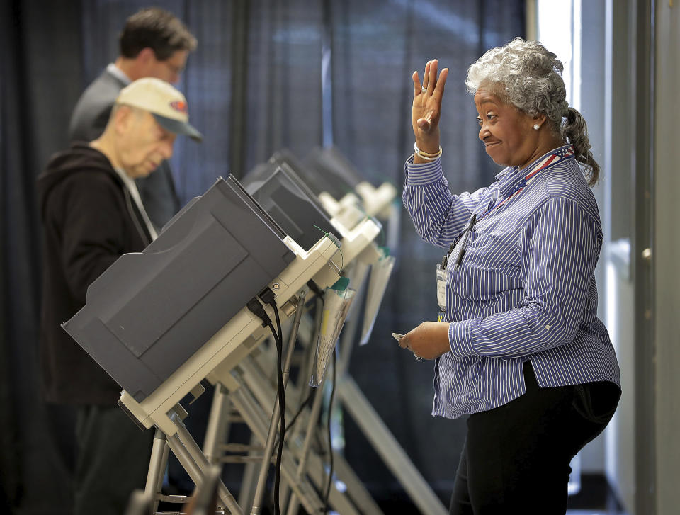 Poll worker Denetria Cooperidge, right, greets voters at the Mississippi Blvd. Christian Church polling location as voters go to the polls on Tuesday, March 3, 2020, to vote in the Super Tuesday primaries. (Jim Weber/Daily Memphian via AP)