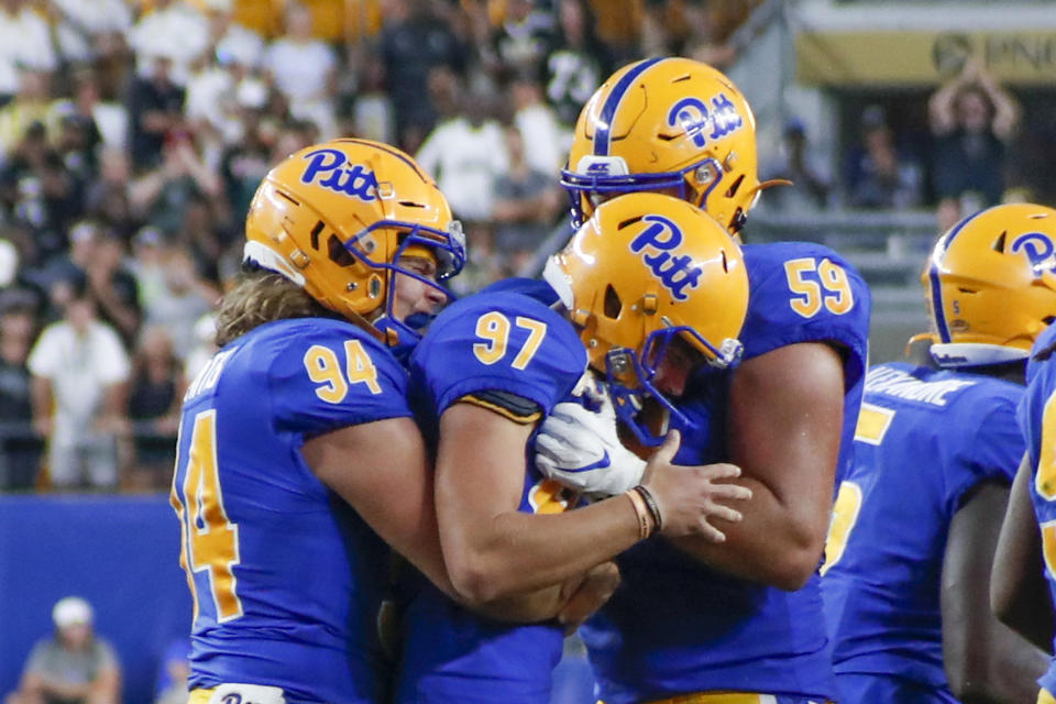 Pittsburgh placekicker Alex Kessman (97) is greeted by teammates long snapper Cal Adomitis (94) and Carson Van Lynn after he made the extra point that gave Pitt the lead over Central Florida during the second half of an NCAA college football game, Saturday, Sept. 21, 2019, in Pittsburgh. Kessman had missed two field goals in the game. (AP Photo/Keith Srakocic)