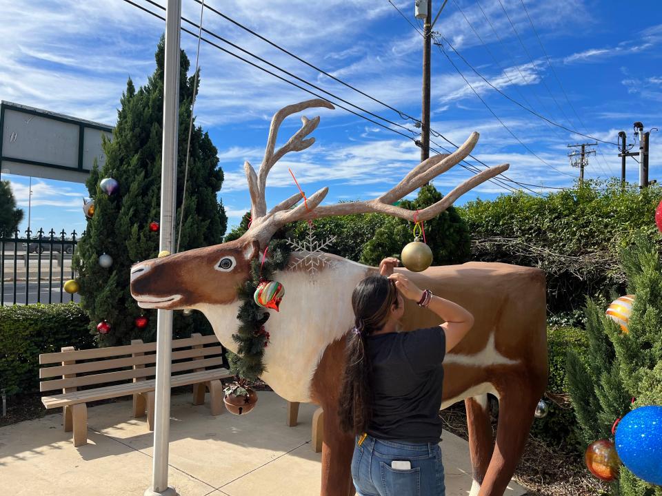 Avilene Aguilar, 13, decorates a reindeer Friday at Santa's Village in Nyeland Acres in preparation for the upcoming Santa to the Sea toy run.
