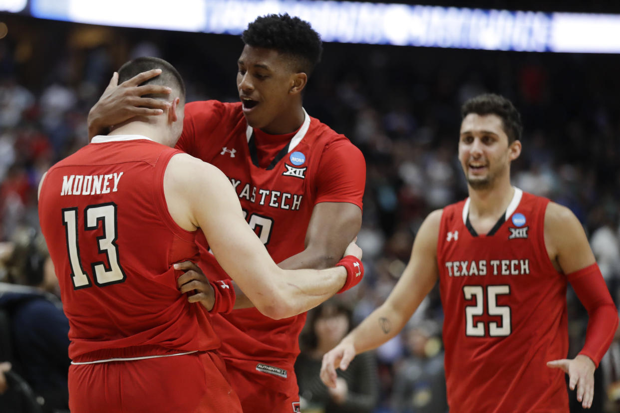 Texas Tech's Matt Mooney,  Jarrett Culver and Davide Moretti, from left, celebrate the team's 75-69 win over Gonzaga during the West Regional final in the NCAA men's college basketball tournament Saturday, March 30, 2019, in Anaheim, Calif. (AP Photo/Marcio Jose Sanchez)