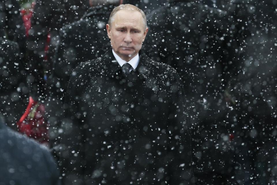 FILE - In this Thursday, Feb. 23, 2017 file photo, snow falls as Russian President Vladimir Putin attends a wreath-laying ceremony marking the Defenders of the Fatherland Day at the Tomb of the Unknown Soldier in Moscow, Russia. With a year to go before Russia's presidential election, President Vladimir Putin is set to glide easily to another term against a familiar pack of torpid rivals - leftovers from past races. (AP Photo/Ivan Sekretarev, file)