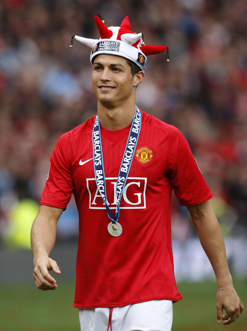 FILE - In this Saturday May 16, 2009 file photo, Manchester United's Cristiano Ronaldo smiles as the team celebrate winning the English Premier League after their 0-0 draw against Arsenal at Old Trafford Stadium, Manchester, England. Ronaldo, who joined Juventus for this season from Real Madrid, became the first player to win the English Premier League (with Manchester United), the Spanish league (with Madrid) and Serie A. (AP Photo/Jon Super, File)