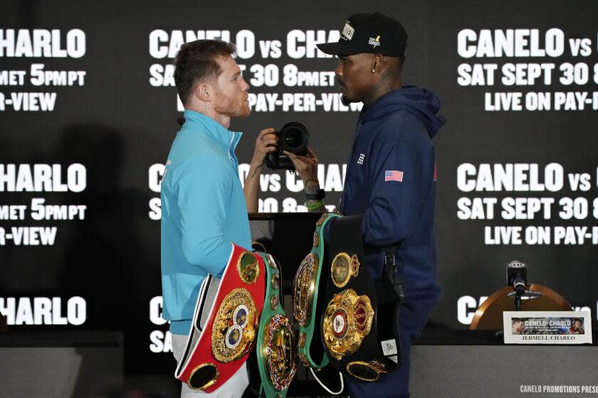 Canelo Alvarez, left, of Mexico, and Jermell Charlo pose during a news conference Wednesday, Sept. 27, 2023, in Las Vegas. The two are scheduled to fight in a super middleweight title boxing match Saturday in Las Vegas. (AP Photo/John Locher)