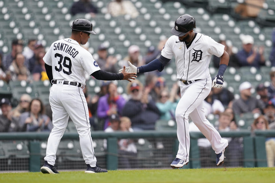 Detroit Tigers' Willi Castro celebrates his home run with third base coach Ramon Santiago (39) in the second inning of a baseball game against the Kansas City Royals in Detroit, Thursday, Sept. 29, 2022. (AP Photo/Paul Sancya)