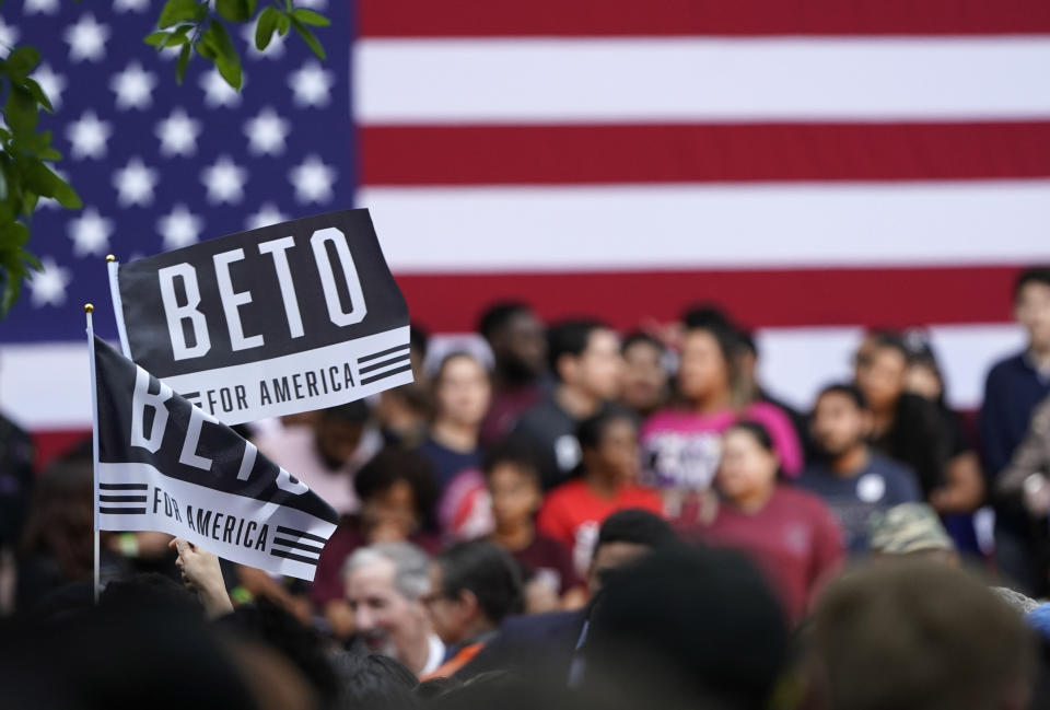 Supporters of Democratic presidential candidate and former Texas congressman Beto O'Rourke hold up flags before the start of his presidential campaign kickoff rally in Houston, Saturday, March 30, 2019. (AP Photo/David J. Phillip)