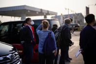 Members of the media work outside Hankou Railway Station in Wuhan