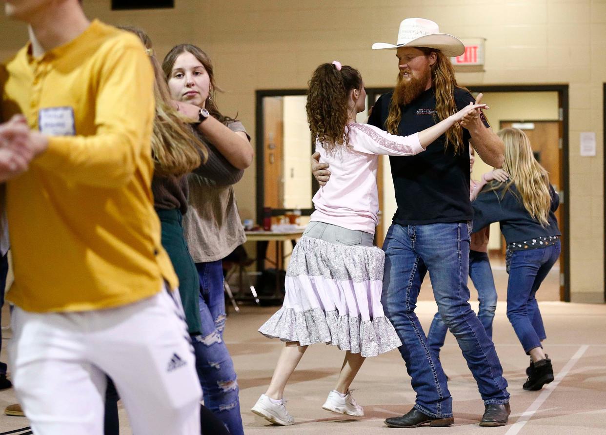 Logan Seagren, right, is seen here dancing at the Traditional Dance & Music Society of the Ozarks event at King's Way United Methodist Church in Springfield on March 18, 2023.