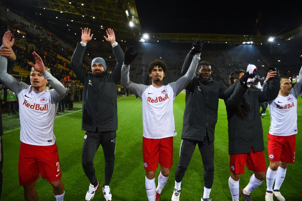 Salzburg players celebrate with their travelling supporters after the historic victory.