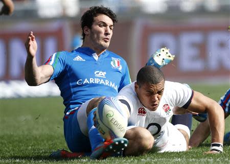 England's Luther Burrell (R) is tackled by Italy's Leonardo Sarto during their Six Nations rugby union match at Olympic Stadium in Rome March 15, 2014. REUTERS/Alessandro Bianchi