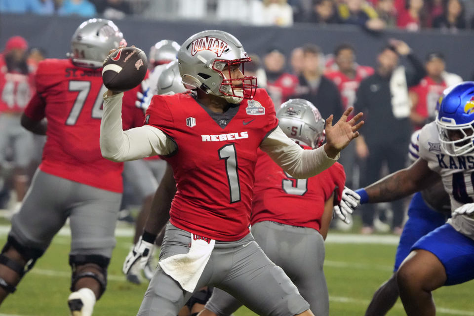 UNLV quarterback Jayden Maiava (1) looks for a receiver during the first half of the team's Guaranteed Rate Bowl NCAA college football game against Kansas on Tuesday, Dec. 26, 2023, in Phoenix. (AP Photo/Rick Scuteri)