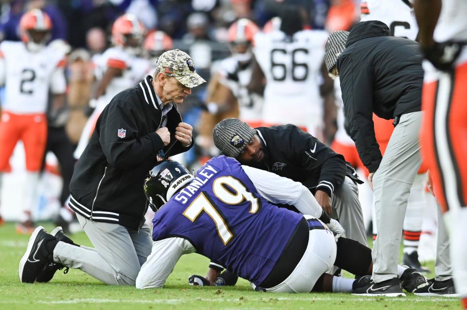 Nov 12, 2023; Baltimore, Maryland, USA; Baltimore Ravens offensive tackle Ronnie Stanley (79) grabs his leg as medical personal examine him own the field during the second half against the Cleveland Browns at M&T Bank Stadium. Mandatory Credit: Tommy Gilligan-USA TODAY Sports