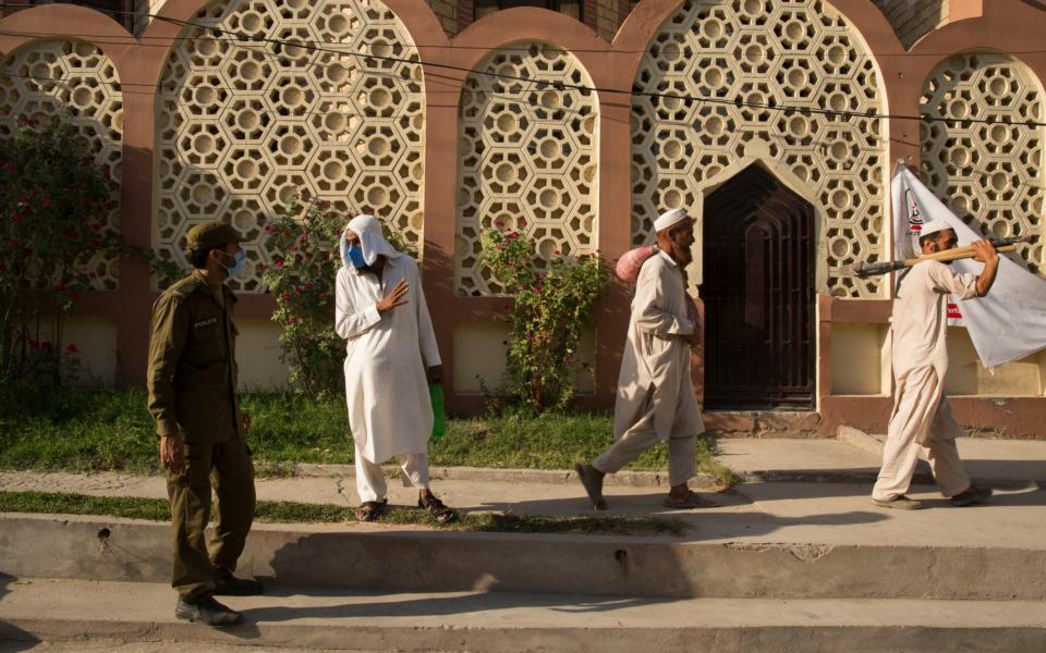 Police stop labourers from entering a checkpoint