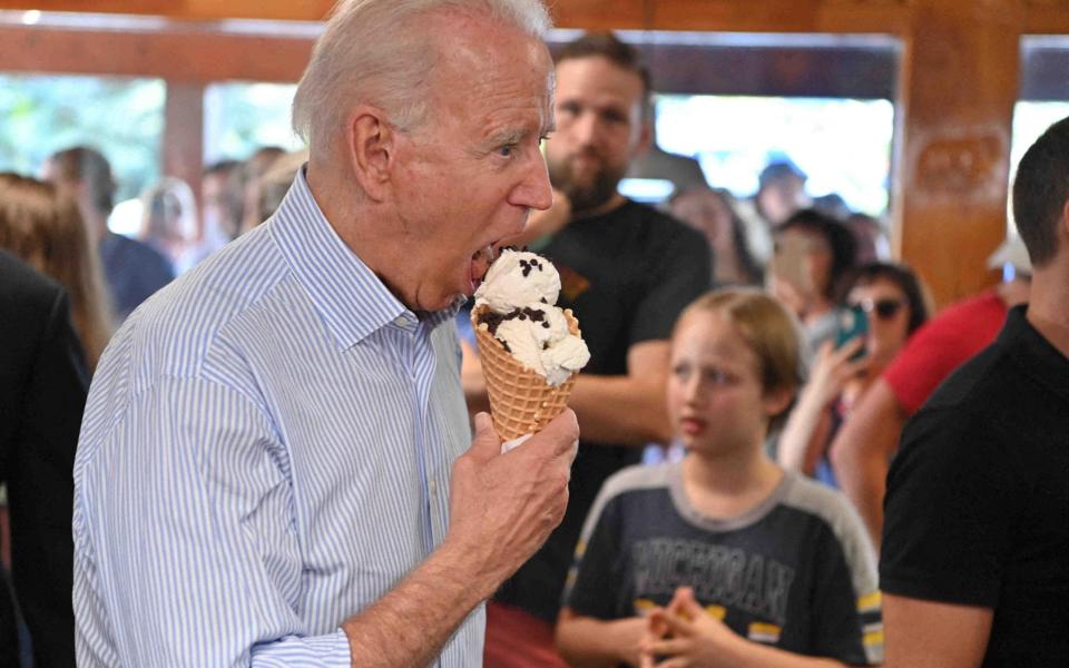 US President Joe Biden eats ice cream at Moomers Homemade Ice Cream in Traverse City, Michigan ahead of July 4 celebrations - AFP