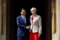 Britain's Prime Minister Theresa May greets Prime Minister Shinzo Abe of Japan during a visit to Chequers, near Wendover, Britain April 28, 2017. REUTERS/Kirsty Wigglesworth/Pool