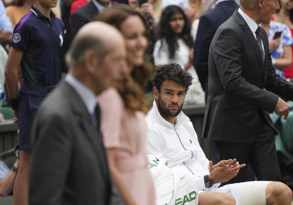 Italy's Matteo Berrettini watches Kate, Duchess of Cambridge, and the Duke of Kent arrive for the presentation ceremony for the men's singles final match on day thirteen of the Wimbledon Tennis Championships in London, Sunday, July 11, 2021. (AP Photo/Alberto Pezzali)