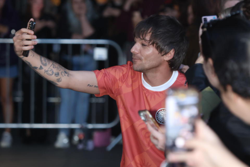 Louis Tomlinson greeting fans as he leaves BBC Broadcasting House in London, after an appearance on The One Show. Picture date: Wednesday September 7, 2022.