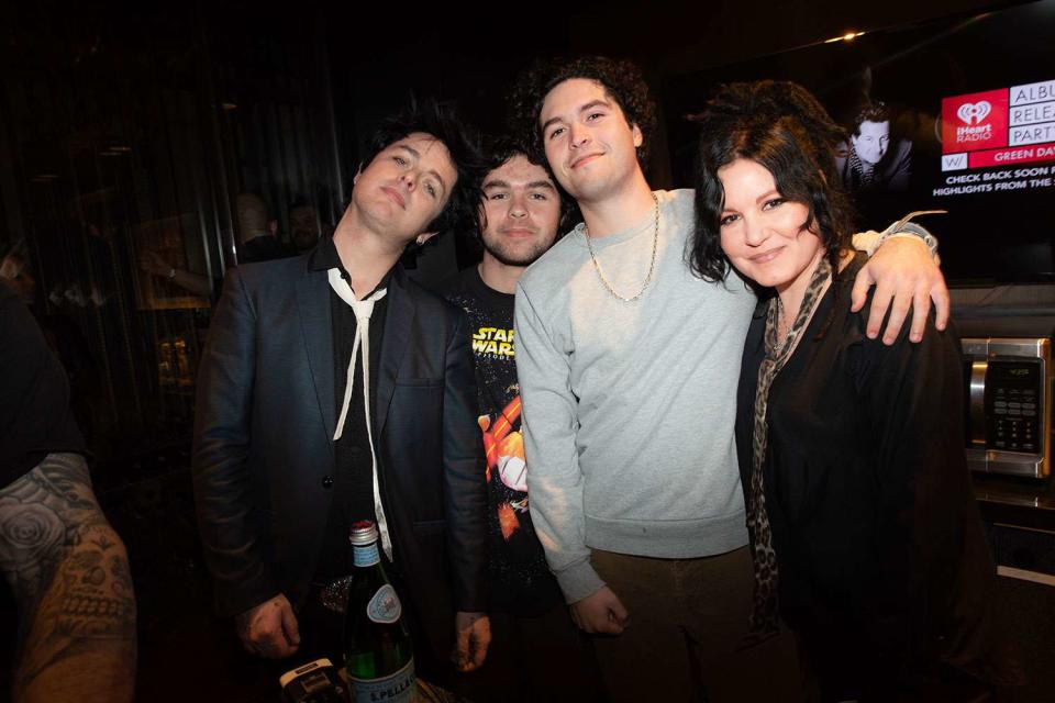 <p>Greg Schneider</p> Billie Joe Armstrong with sons Jakob and Joey and wife Adrienne in 2020