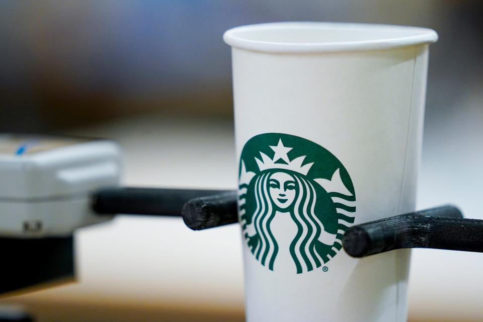 A single-use cup undergoes a rigidity test at the Tryer Center at Starbucks headquarters, Wednesday, June 28, 2023, in Seattle. Paper pulp from recycled cups has shorter fibers than virgin pulp, which means less rigidity, important particularly with hot coffee.