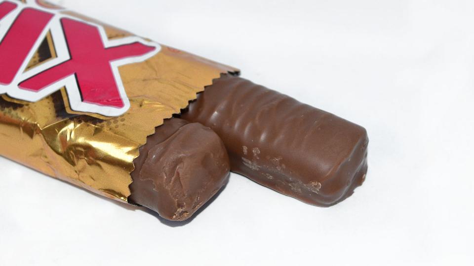 a candy in a bag lies on a white background