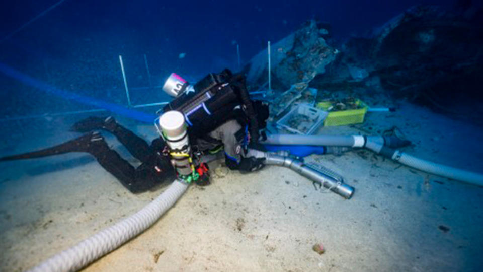 A diver excavates the wreck of an American B-24 Liberator bomber in the waters near Malta.