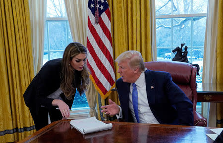 U.S. President Donald Trump confers with White House Communications Director Hope Hicks during an interview with Reuters at the White House in Washington, U.S., January 17, 2018. REUTERS/Kevin Lamarque