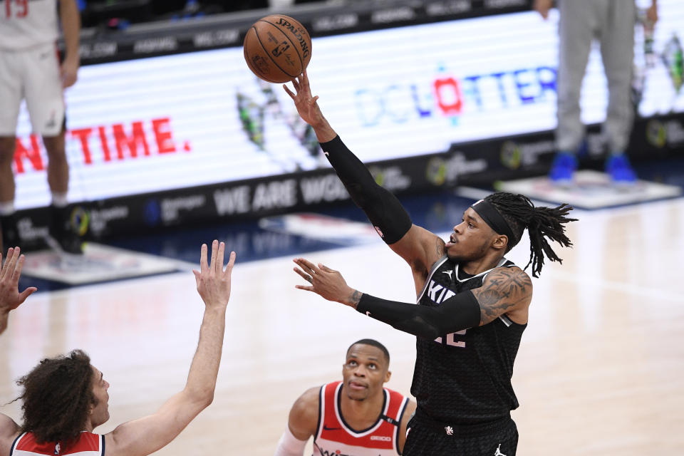 Sacramento Kings center Richaun Holmes, right, shoots against Washington Wizards guard Russell Westbrook, center, and center Robin Lopez, bottom left, during the second half of an NBA basketball game, Wednesday, March 17, 2021, in Washington. (AP Photo/Nick Wass)