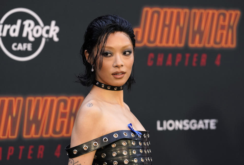 Rina Sawayama, a cast member in "John Wick: Chapter 4," looks back for photographers at the premiere of the film, Monday, March 20, 2023, at the TCL Chinese Theatre in Los Angeles. (AP Photo/Chris Pizzello)
