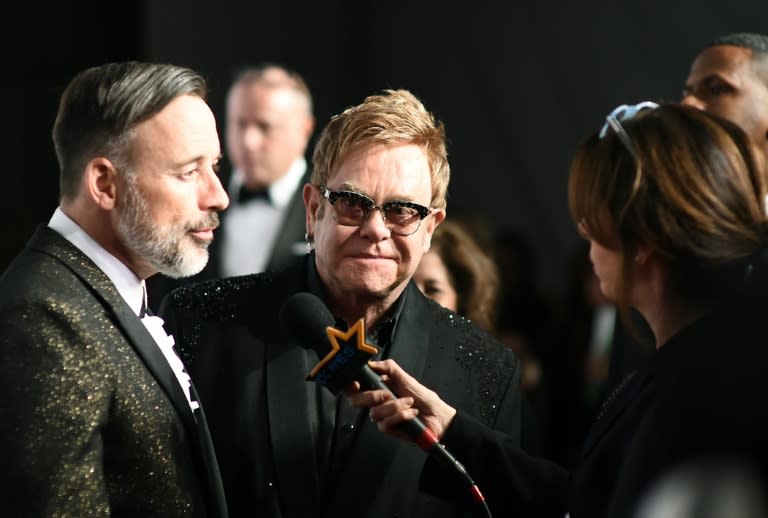 On "The Open Chord," Elton John (C), pictured on October 28, 2014, delights in family life he shares with David Furnish (L)