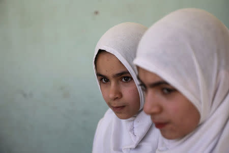 Pupils stand in from their classroom at an elementary school in eastern Mosul, Iraq, April 17, 2017. REUTERS/Marko Djurica