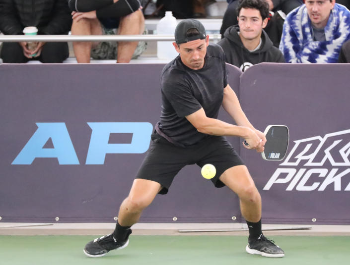 MESA, AZ - DECEMBER 3: Julian Arnold hits a backhand drive shot against JW Johnson and Dekel Bar in the quarter finals of the APP Sunmed Mesa Open Pickleball Men&#39;s PRO Doubles division at Legacy Sports Park on December 3, 2022 in Mesa, Arizona. (Photo by Bruce Yeung/Getty Images)