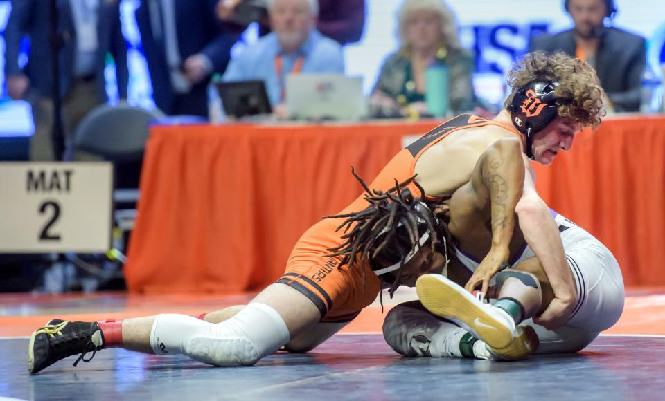 Washington's Peyton Cox, top, grapples with Mascoutah's Santino Robinson in the 132-pound match of the  Class 2A state wrestling tournament Saturday, Feb. 18, 2023 at State Farm Arena in Champaign.