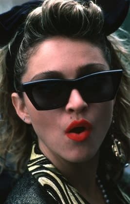 Wayfarer-inspired glasses and red lipstick