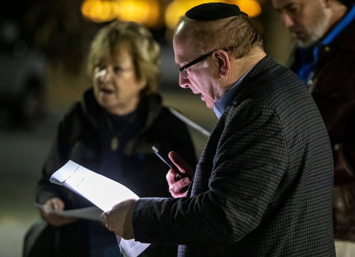 Rabbi Steven Rosenberg leads a gathering in song during a Hanukkah celebration Thursday outside Temple Isaiah in Palm Springs.