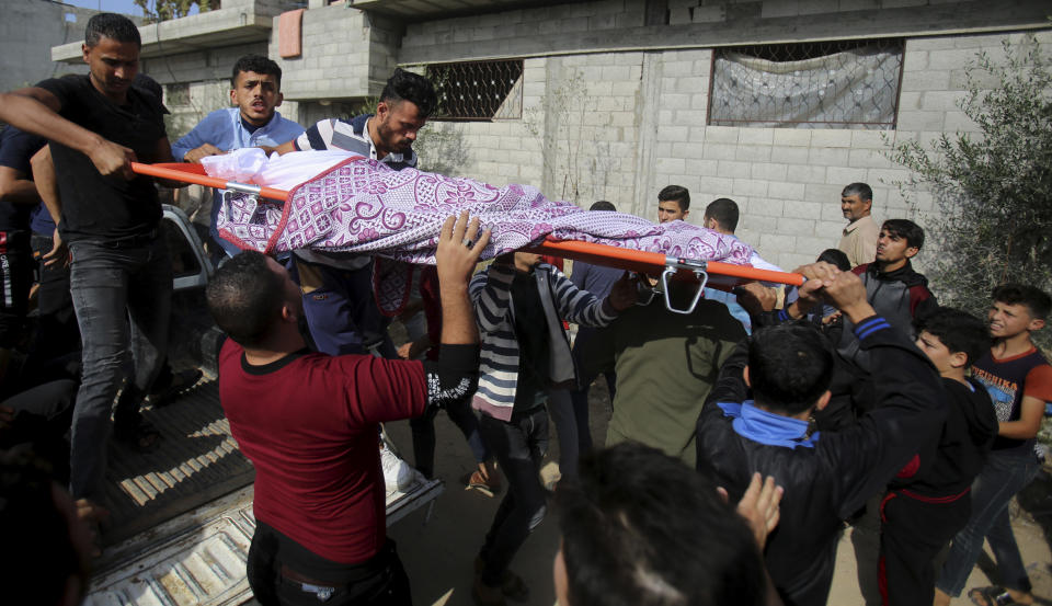 Mourners carry the body of Amir Ayyad, 7, into his family house during his funeral in Gaza City, Wednesday, Nov. 13, 2019. Amir was killed with his father and a sibling during an Israeli airstrikes on a motorcycle near his family house in Gaza City. Israeli airstrikes pounded Islamic Jihad targets in Gaza on Wednesday as militants resumed rocket fire toward Israel after a brief overnight lull, raising the death toll to tens of Palestinians, including a 7-year-old boy and two other minors, in the heaviest round of fighting in months. (AP Photo/Adel Hana)