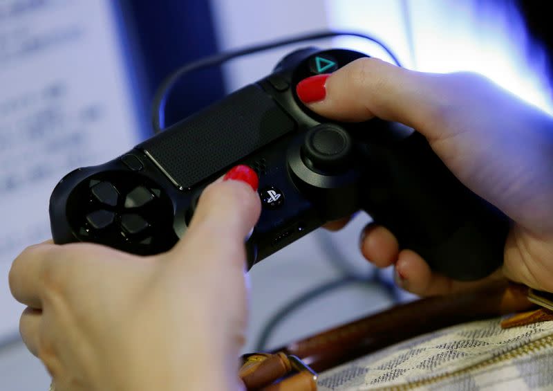 A woman plays Sony's PlayStation 4 at Tokyo Game Show 2016 in Chiba