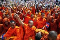 Buddhist monks who support the opposition Cambodia National Rescue Party (CNRP) gesture during a protest at Freedom Park in Phnom Penh September 15, 2013. Thousands of demonstrators defied road blocks and a jail threat to hold a march in Cambodia's capital on Sunday in a last-gasp push for an independent probe into a July election they say was fixed to favour the ruling party. (REUTERS/Athit Perawongmetha)