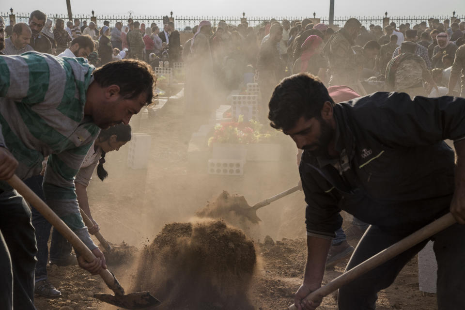 People attend funerls of Syrian Democratic Forces fighters killed recently fighting Turkish forces in the town of Hasakeh, north Syria, Monday, Oct. 21, 2019. (AP Photo/Baderkhan Ahmad)