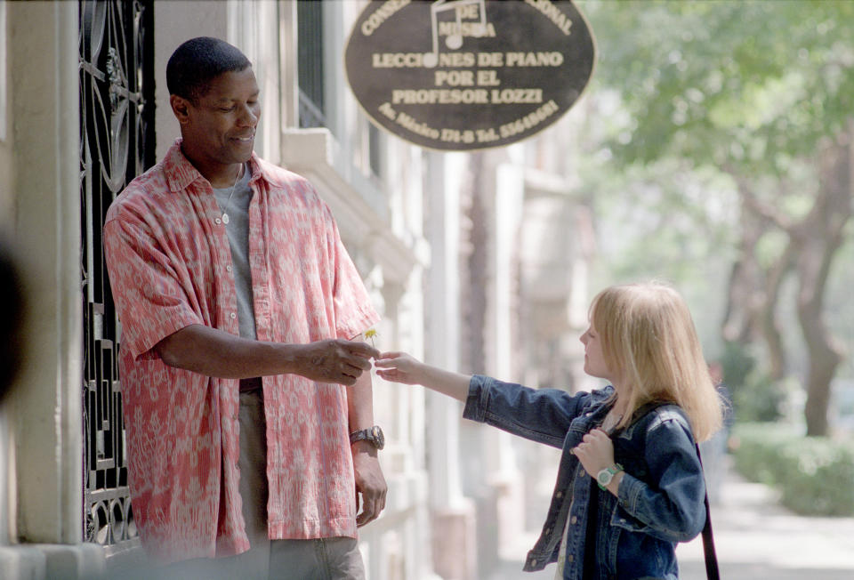 American actors Denzel Washington and Dakota Fanning on the set of Man of Fire, directed and produced by Tony Scott. (Photo by Twentieth Century Fox/Regency/Sunset Boulevard/Corbis via Getty Images)