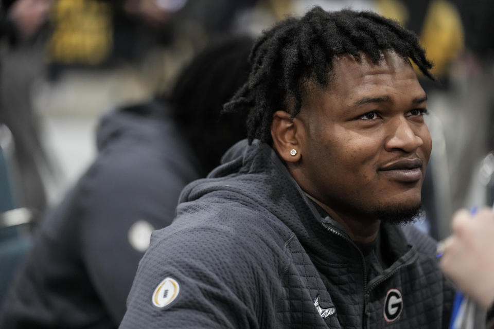 FILE - Georgia defensive lineman Jalen Carter speaks during media day ahead of the national championship NCAA College Football Playoff game between Georgia and TCU, Saturday, Jan. 7, 2023, in Los Angeles. Carter, projected as one of the top players in next month's NFL draft, has been charged with reckless driving and racing in conjunction with the crash that killed offensive lineman Devin Willock and a recruiting staff member. The Athens-Clarke County Police Department has issued an arrest warrant, obtained Wednesday, March 1, by The Associated Press, which alleges Carter was racing his 2021 Jeep Trackhawk against the 2021 Ford Expedition driven by the recruiting staffer, 24-year-old Chandler LeCroy, which led to the Jan. 15 wreck. (AP Photo/Marcio Jose Sanchez)