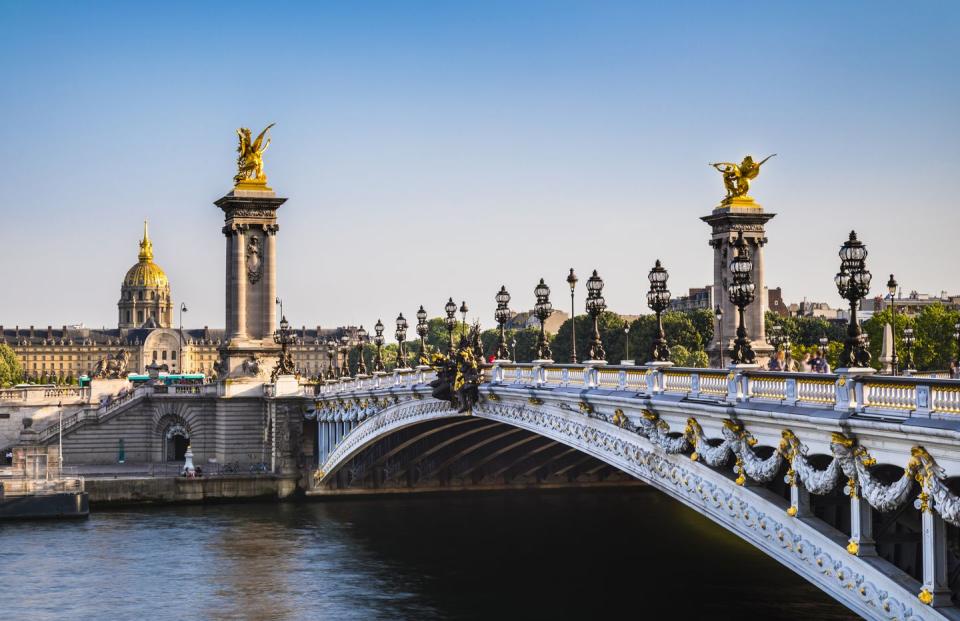 bridge alexandre iii over seine river against clear blue sky in paris, france