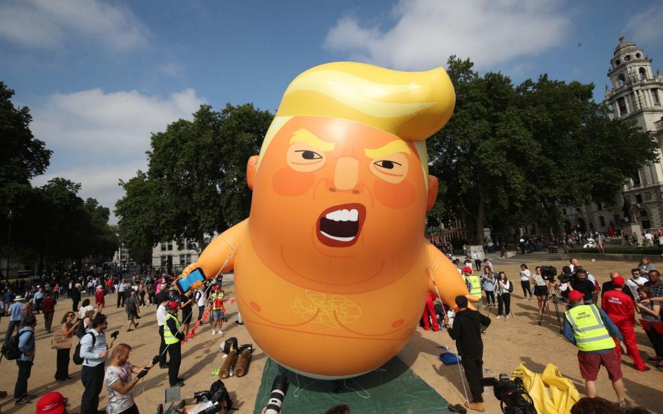 The huge inflatable depicts the US president in a nappy and clutching a mobile phone - PA