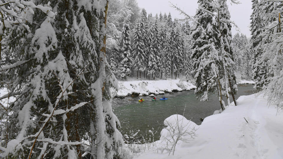 Kayaker make their way on the river Saalach on Saturday, Jan. 12, 2019 in Lofer, Austrian province of Salzburg.(AP Photo/Kerstin Joensson)