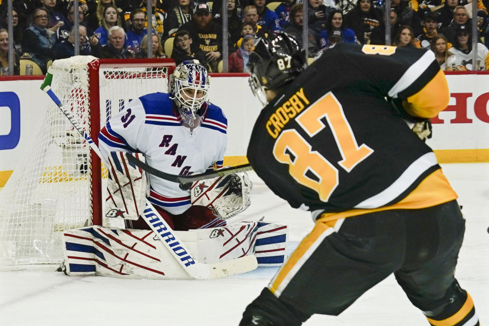 Pittsburgh Penguins' Sidney Crosby (87) shoots on New York Rangers goaltender Igor Shesterkin (31), but doesn't score, during the second period of an NHL hockey game, Saturday, Feb. 26, 2022, in Pittsburgh. (AP Photo/Keith Srakocic)