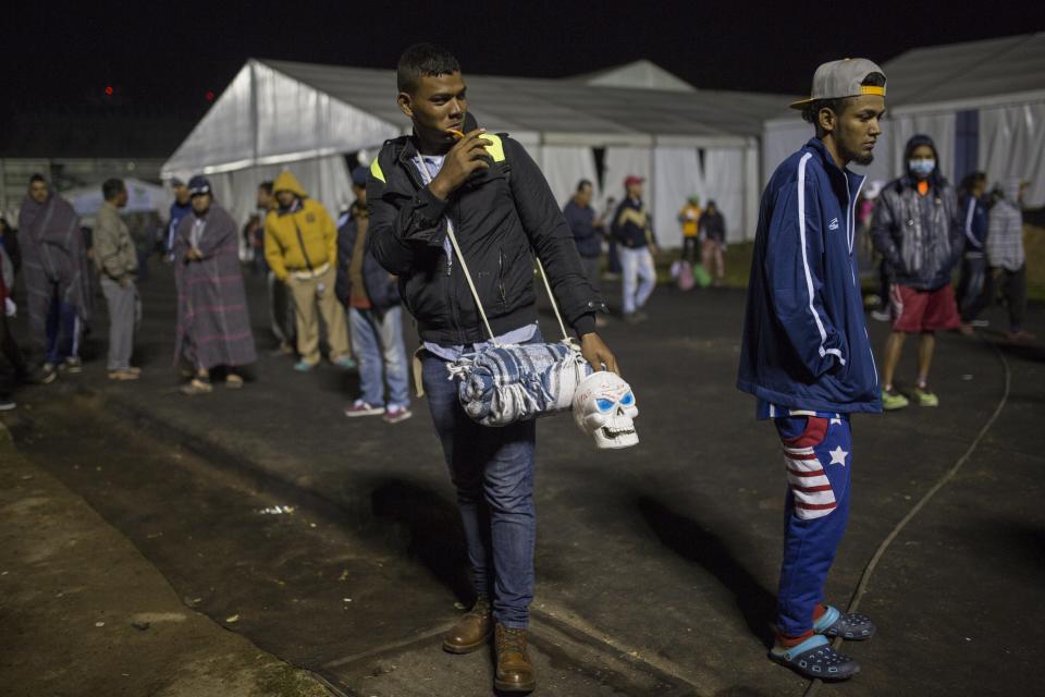 A Central American migrant prepares to leave the temporary shelter in the Jesus Martinez stadium, in Mexico City, Friday, Nov. 9, 2018. A group of 500 migrants decided to get ahead of the caravan and head north towards the city of Queretaro. (AP Photo/Rodrigo Abd)