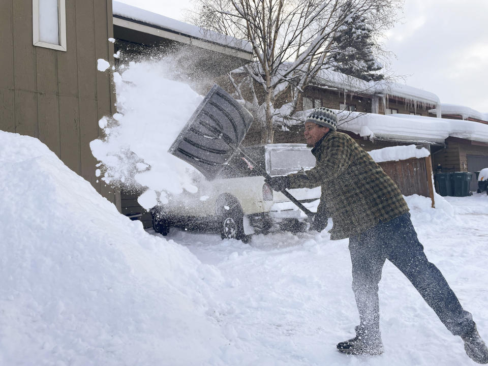 Damon Fitts shovels the driveway at his home, Monday, Jan. 29, 2024, in Anchorage, Alaska. (AP Photo/Mark Thiessen)