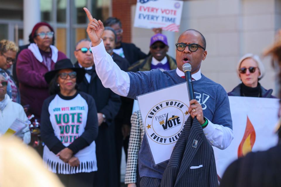 The Rev. Jay Augustine, the pastor of Durham's St. Joseph AME Church, spoke outside a polling place about new voting rules he said were attempts to suppress the vote.