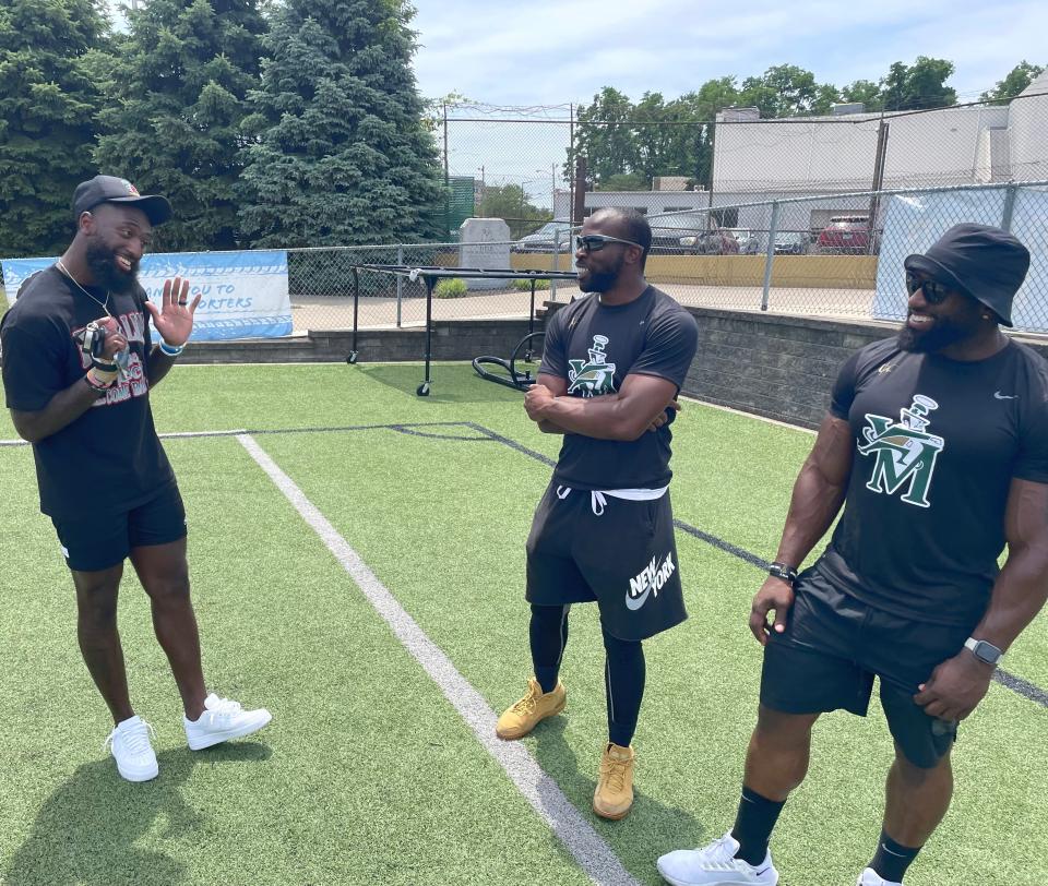 Indianapolis Colts wide receiver Parris Campbell, left, talks to fellow Akron natives and former NFL players Doran Grant, middle, and Delone Carter, right, during a youth football camp Saturday at St. Vincent-St. Mary High School in Akron.