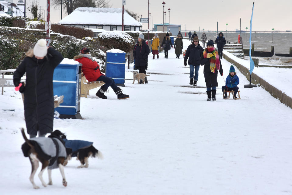 SOUTHEND, ENGLAND - FEBRUARY 11: People walk along the promenade at Chalkwell beach after more snow fell overnight on February 11, 2021 in Southend on Sea, England. Storm Darcy brought heavy snow in Scotland and South East England over last weekend which kick started a week of freezing temperatures across many parts of the UK. (Photo by John Keeble/Getty Images)