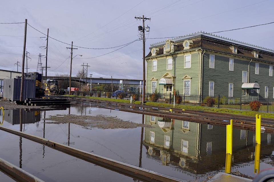 Standing water is left after overnight rains in front of Miss Laura's Visitors Center, 2 N B Street, Friday, March 3, 2023