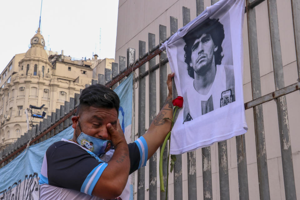 An Argentinian fan weeps in front of a portrait of Diego Maradona following news of his death. Three days of mourning was declared in his country. (PHOTO: Muhammed Emin Canik/Anadolu Agency via Getty Images)